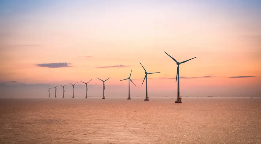 Offshore turbines at sunset